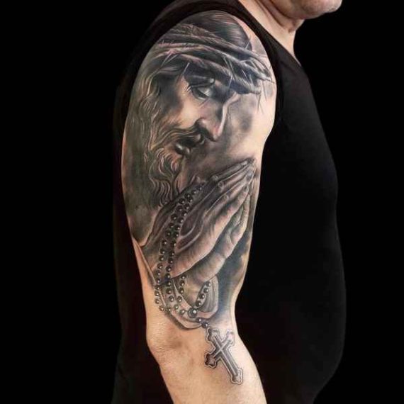 Tatuaje realista en Zaragoza Jesucristo con rosario